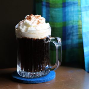 new deal spanish coffee topped with whipped cream and cinnamon