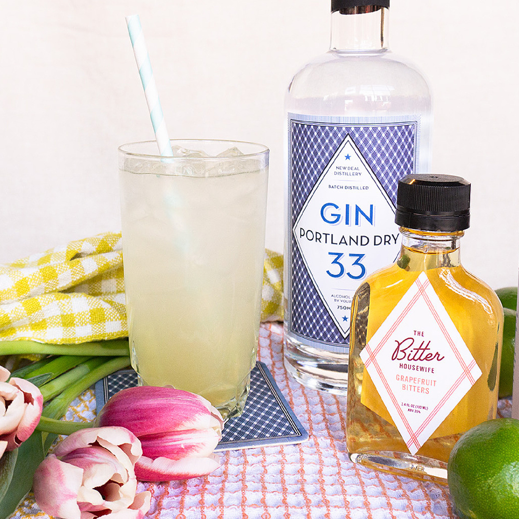 Pomelo Squeez cocktail next to Gin 33 and grapefruit bitters