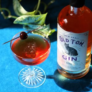 new deal martinez in a coupe with a skewered cherry garnish