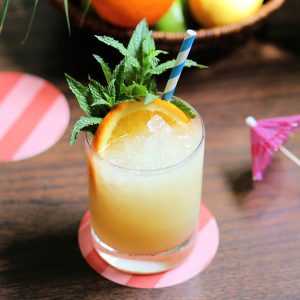 Frozen scorpion cocktail with mint and an orange wheel for garnish