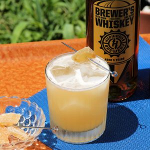 penicillin cocktail with ginger liqueur , hopworks brewewrs whiskey and candied ginger garnish